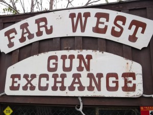 The sign outside a Southern Oregon antique store seems to frame the question: Exchange guns, but for what?