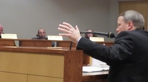 In a suit, Public Works Director Mark Shepard makes a point related to a 2 per cent water rate hike, which the council approved.