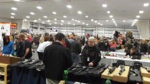 Checking the merchandise at an Albany gun show.
