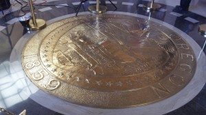 The Oregon seal under the Capitol dome.