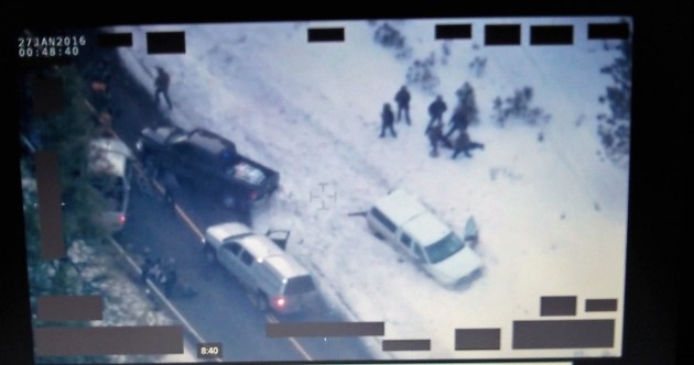 FBI video: Law officers gather around the body of the dead rancher after others in the truck have come out.