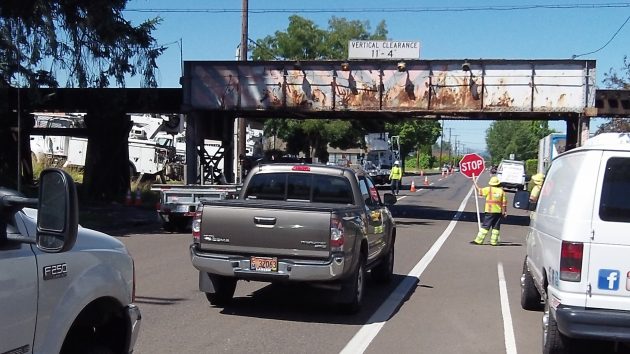 Taffic is flagged to a stop at the Lafayette Street railroad overpass on First Avenue.