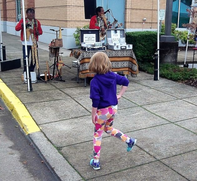Andean melodies prompted a little girl to dance at the Albany Farmers' Market Saturday.